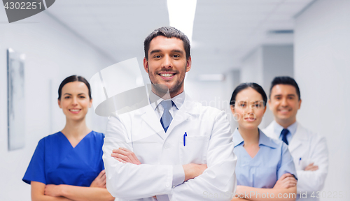 Image of happy group of medics or doctors at hospital