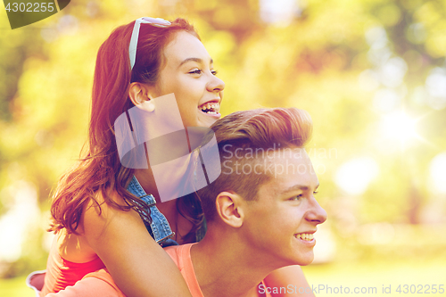 Image of happy teenage couple having fun at summer park