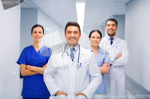 Image of happy group of medics or doctors at hospital