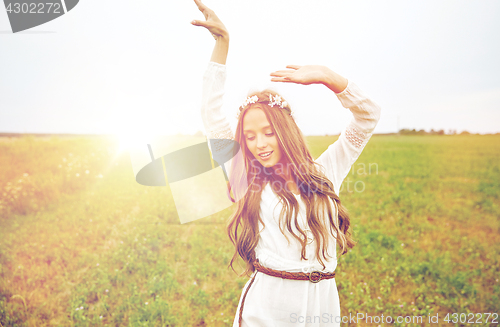 Image of smiling young hippie woman on cereal field