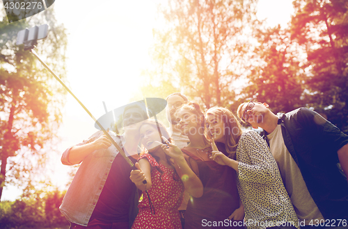 Image of friends taking selfie at party in summer garden