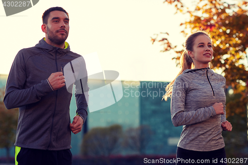 Image of couple running outdoors