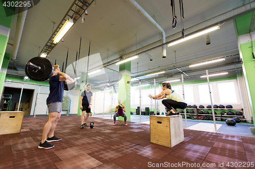 Image of group of people exercising in gym