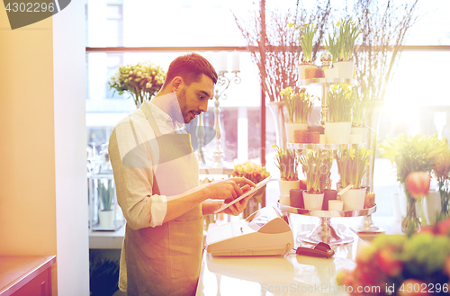 Image of man with tablet pc computer at flower shop