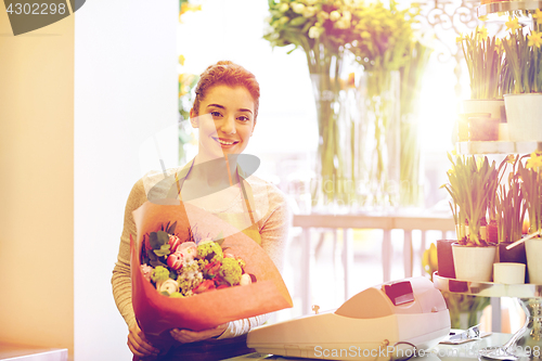 Image of smiling florist woman with bunch at flower shop