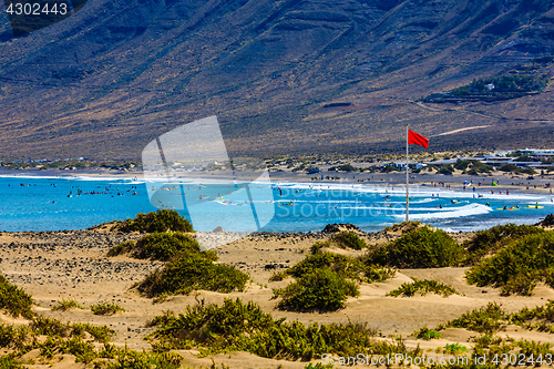 Image of Surfers beach Famara on Lanzarote always has a red flag.