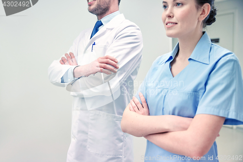 Image of close up of doctor and nurse at hospital corridor