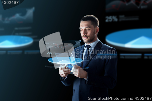 Image of businessman with tablet pc and virtual charts