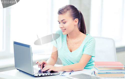 Image of smiling student girl with laptop