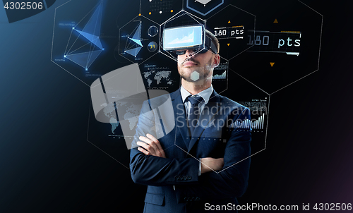 Image of businessman in virtual reality headset over black