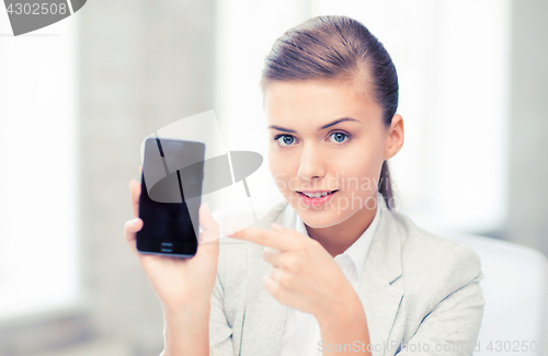 Image of businesswoman with smartphone in office