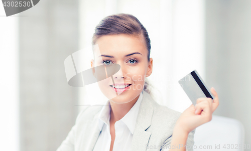 Image of smiling businesswoman showing credit card