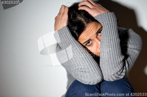 Image of unhappy woman crying on floor