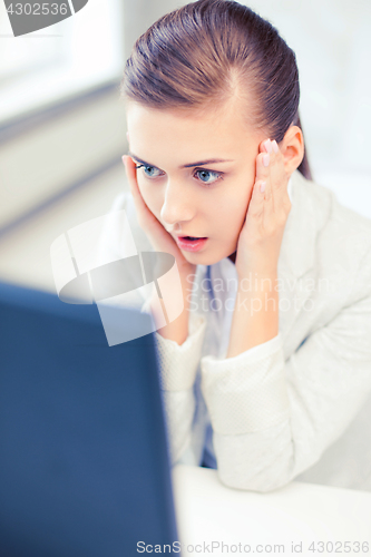 Image of stressed businesswoman with computer