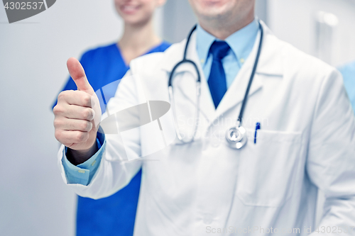 Image of close up of doctors at hospital showing thumbs