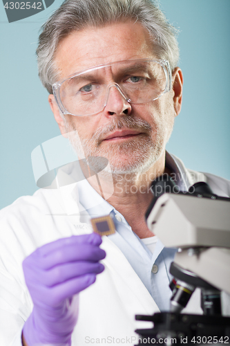 Image of Senior life science research researching in modern scientific laboratory.