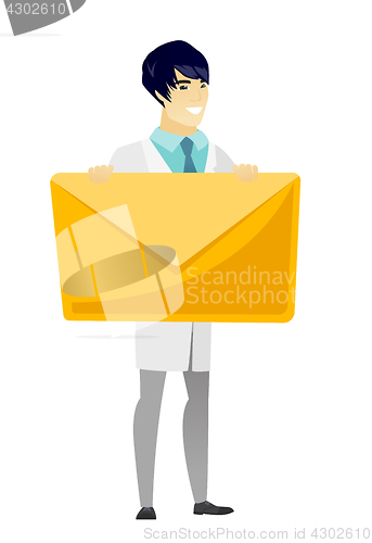 Image of Smiling doctor holding a big envelope.