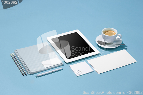 Image of The laptop, pens, phone, note with blank screen on table