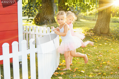 Image of The two little girls at playground against park or green forest