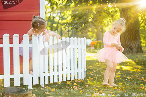 Image of The two little girls at playground against park or green forest