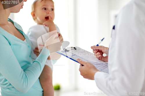 Image of woman, baby and doctor with clipboard at clinic