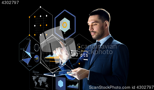 Image of businessman with tablet pc and virtual screen