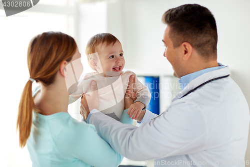 Image of happy woman with baby and doctor at clinic