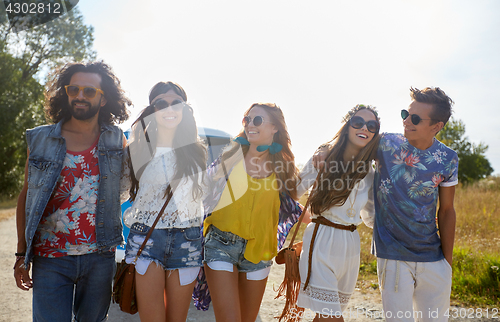 Image of smiling happy young hippie friends at minivan car