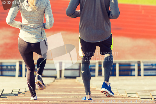 Image of close up of couple running downstairs on stadium