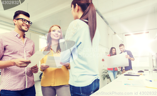 Image of creative team on coffee break talking at office