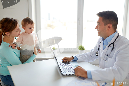Image of woman with baby and doctor with laptop at clinic