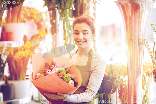 Image of smiling florist woman with bunch at flower shop