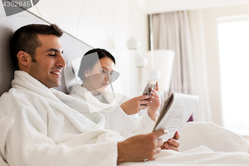 Image of happy couple in bed at home or hotel room