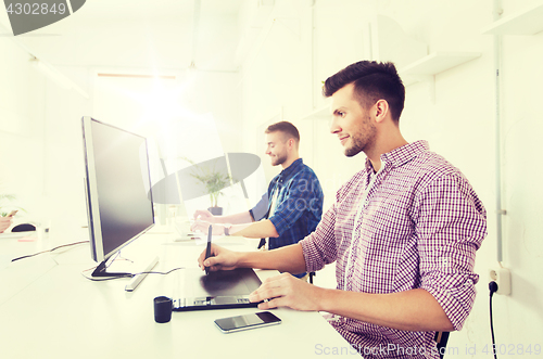 Image of man or designer with computer and tablet at office