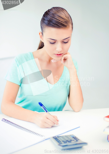 Image of student girl with notebook and calculator