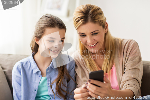 Image of happy family with smartphone at home