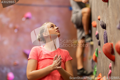 Image of man and woman exercising at indoor climbing gym