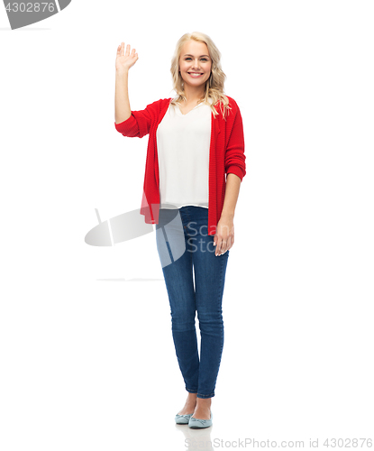 Image of happy smiling young woman waving hand over white