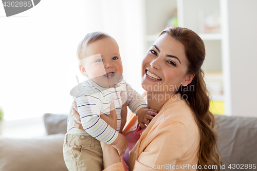 Image of happy young mother with little baby at home