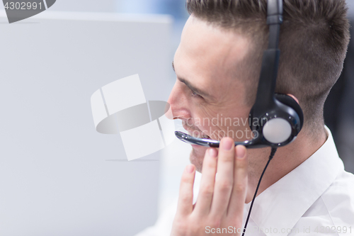 Image of male call centre operator doing his job