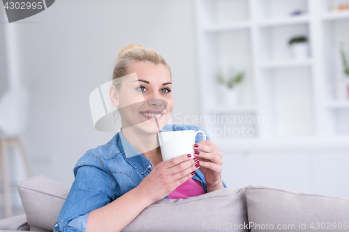 Image of woman enjoying a cup of coffee