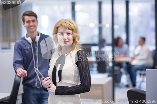 Image of Business People Working With Tablet in startup office