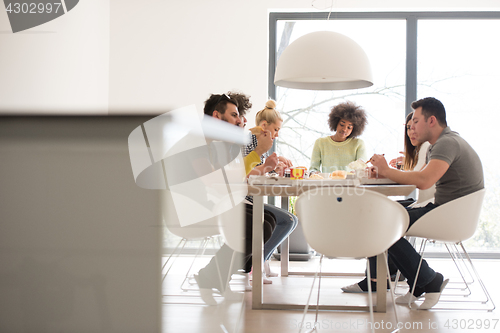 Image of multiethnic group of happy friends lunch time