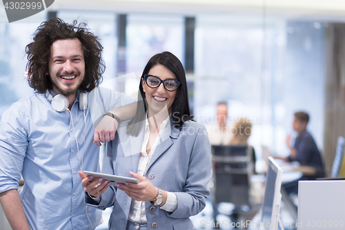 Image of Business People Working With Tablet in startup office