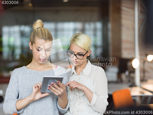 Image of Pretty Businesswomen Using Tablet In Office Building during conf