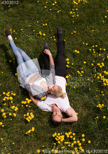 Image of man and woman lying on the grass