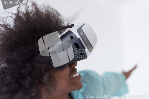 Image of black girl using VR headset glasses of virtual reality