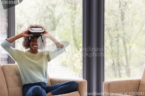 Image of black woman using VR headset glasses of virtual reality