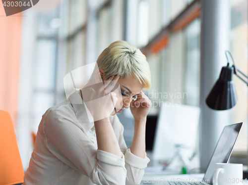 Image of businesswoman using a laptop in startup office