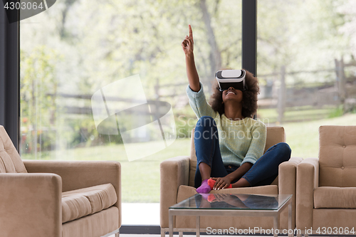 Image of black woman using VR headset glasses of virtual reality